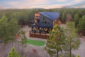 an aerial view of a house in the woods at All FORE The View Cabin in Hochatown in Broken Bow