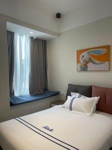 a bedroom with a bed and a window with a dog picture at Claire Aparthotel in Kigali