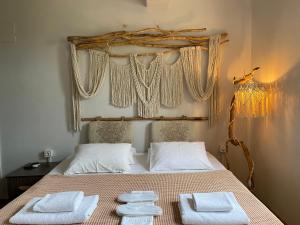 a bedroom with a bed with white towels on it at Vayu Hotel&Tiny Houses in Canakkale