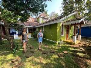 two people standing in front of a house at The Amrit Goa in Candolim