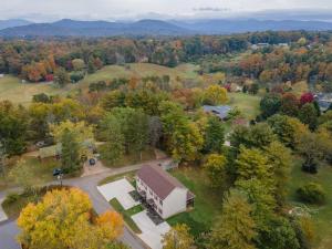 an aerial view of a house with a barn at Panorama Place! Comfy Asheville Retreat Sleeps 10! in Asheville