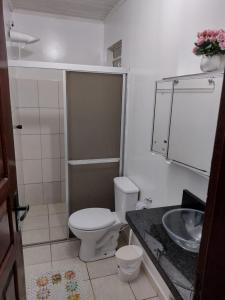 a small bathroom with a toilet and a sink at Meu Oca in Boa Vista