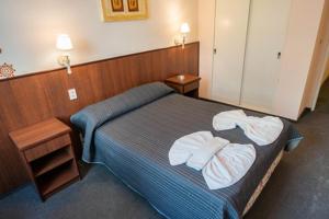 a hotel room with a bed with two towels on it at Etoile in Mar del Plata