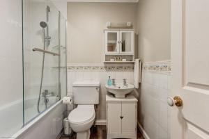 a bathroom with a toilet and a sink and a shower at The Didcot White House in Didcot