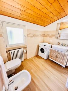 a bathroom with a sink and a washing machine at Casa Biba in Torri del Benaco +47 photos