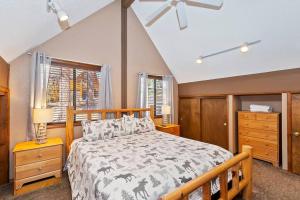 a bedroom with a bed and a dresser and windows at Beautiful 3 BR Cabin/Great Views/Lots of Amenities in Big Bear Lake