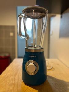 a blue blender sitting on top of a table at Appartement Proche de Disneyland & Paris in Noisy-le-Grand