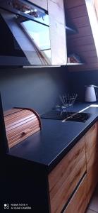 a kitchen with a black counter top and a sink at Goramiba in Jurgów