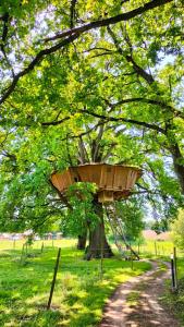 a tree with a bird feeder on top of it at La Libaudière Hebergements Insolites et Chambres d Hotes in Pouzauges +66 photos