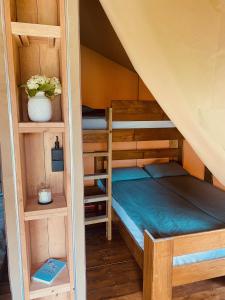 a bedroom with two bunk beds in a attic at GreenValleyGlamping in Šešče pri Preboldu +66 photos