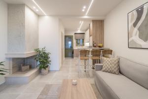 a living room with a couch and a fireplace at Villa Elxis in Limenas