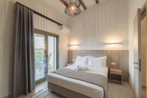 a bedroom with a bed and a large window at Villa Elxis in Limenas