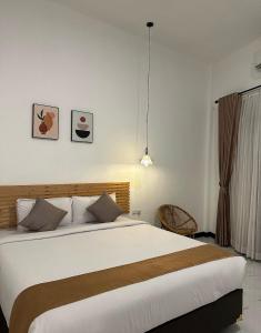 a bedroom with a large bed in a room at Omahku Homestay in Borobudur