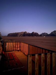 a wooden fence in the middle of the desert at Desert's Soul Wadi Rum in Disah