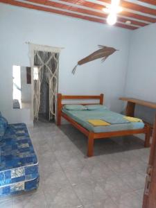 a bedroom with two beds and a whale on the wall at pousada residencial santos in Nova Viçosa