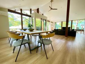 a dining room and living room with a table and chairs at Ahiru Chalet by Hakuba White Fox Company in Hakuba