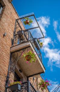 a balcony with flowerpots on a brick building at Twentyone By Vintage Hotel Collections in Tbilisi City