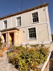 an old house with a garden in front of it at 3 bed penthouse flat with conservatory & roof terrace - city views in Bristol