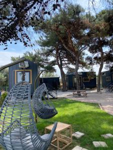 a playground with two chairs and a table and trees at Vayu Hotel&Tiny Houses in Canakkale