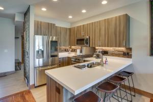 a kitchen with a large island with bar stools at Powder Mountain Home with Private Hot Tub and Views! in Eden