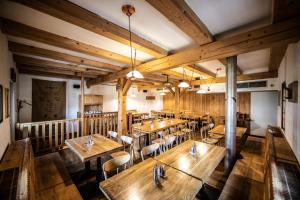 an overhead view of a restaurant with wooden tables and chairs at Pivovar Lyer in Modrava