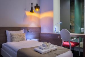Postel nebo postele na pokoji v ubytování Garni Hotel Eter