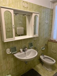 uma casa de banho com um lavatório e um WC em Camere Giulia em Bérgamo