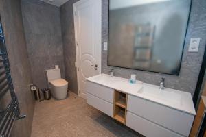 a bathroom with a sink and a toilet and a mirror at For You Rentals Lujoso y elegante ap. en Centro Madrid ALC35 in Madrid