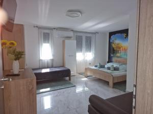 a living room with a bed and a couch at Happy House Vendégház in Bogács