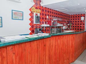 a bar in a restaurant with red tiles at Auberge de Jeunesse HI Nîmes in Nîmes