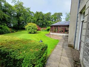 a garden with a building and a lawn at Lara, Maynooth W23P9H6 in Maynooth