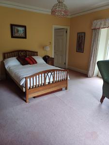 a bedroom with a bed and a chandelier at Lara, Maynooth W23P9H6 in Maynooth