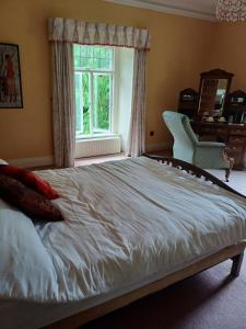 a large bed in a bedroom with a window at Lara, Maynooth W23P9H6 in Maynooth