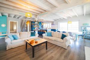 a living room with two couches and a table at Las Cerezas Gozón By Silastur in Luanco