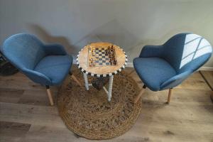 two chairs and a table with a chess game on it at Las Cerezas Gozón By Silastur in Luanco
