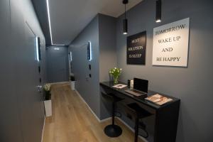 a office with a desk with a laptop on it at Contemporaneamente 147 - Modern & Comfort Rooms in Bari