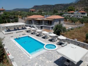 an aerial view of a house with a swimming pool at angelastudios-stoupa in Stoupa