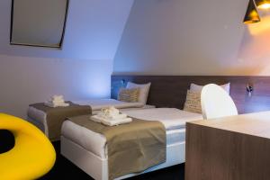 Postel nebo postele na pokoji v ubytování Garni Hotel Eter