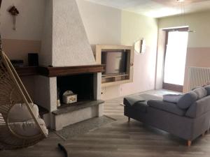 a living room with a couch and a fireplace at Casa in centro Domodossola self check in in Domodossola