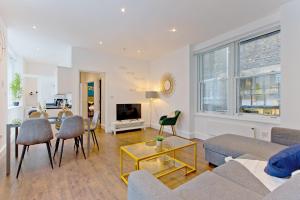 a living room with a couch and a table at Imperial Middlesex Street Apartments in London