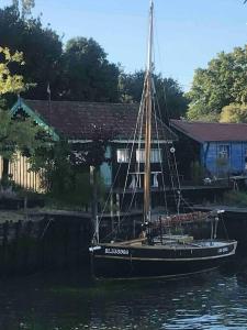a boat sitting in the water in front of a house at Maison de vacances 10 personnes, La Tremblade in La Tremblade +27 photos