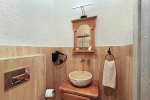 a bathroom with a bowl sink and a mirror at Armel Alaçatı in Alacati