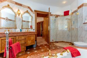 a bathroom with a shower and a sink and a toilet at Berghof-Chalet in Erpfendorf