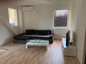 a living room with a couch and a coffee table at Apartmány JG Patince in Patince