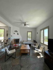 a living room with a couch and a table at Attica Vacation Home in Dhaskalión