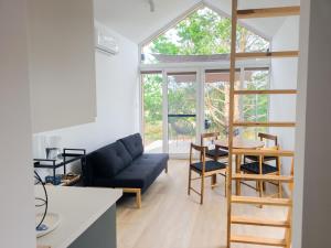 a living room with a black couch and a table at Dywanowy Zakątek in Sominy