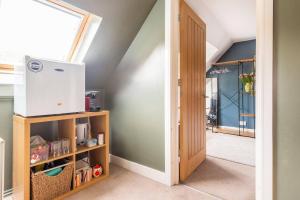 an attic room with a door and a box on a shelf at Room in Guest room - Calm For 3, Handy For Airporttrain Free Parking in Bishops Stortford