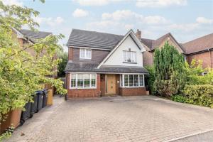 a house with a driveway in front of it at Room in Guest room - Calm For 3, Handy For Airporttrain Free Parking in Bishops Stortford