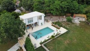 an aerial view of a house with a swimming pool at The Rock Stars Villa With Private Pool And Beach in Danilovgrad