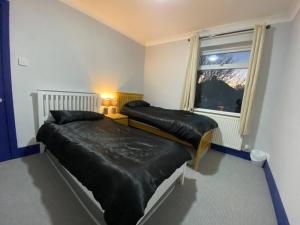 a bedroom with two beds and a window at 3 Room Apartment - Twinsdouble in Kings Lynn